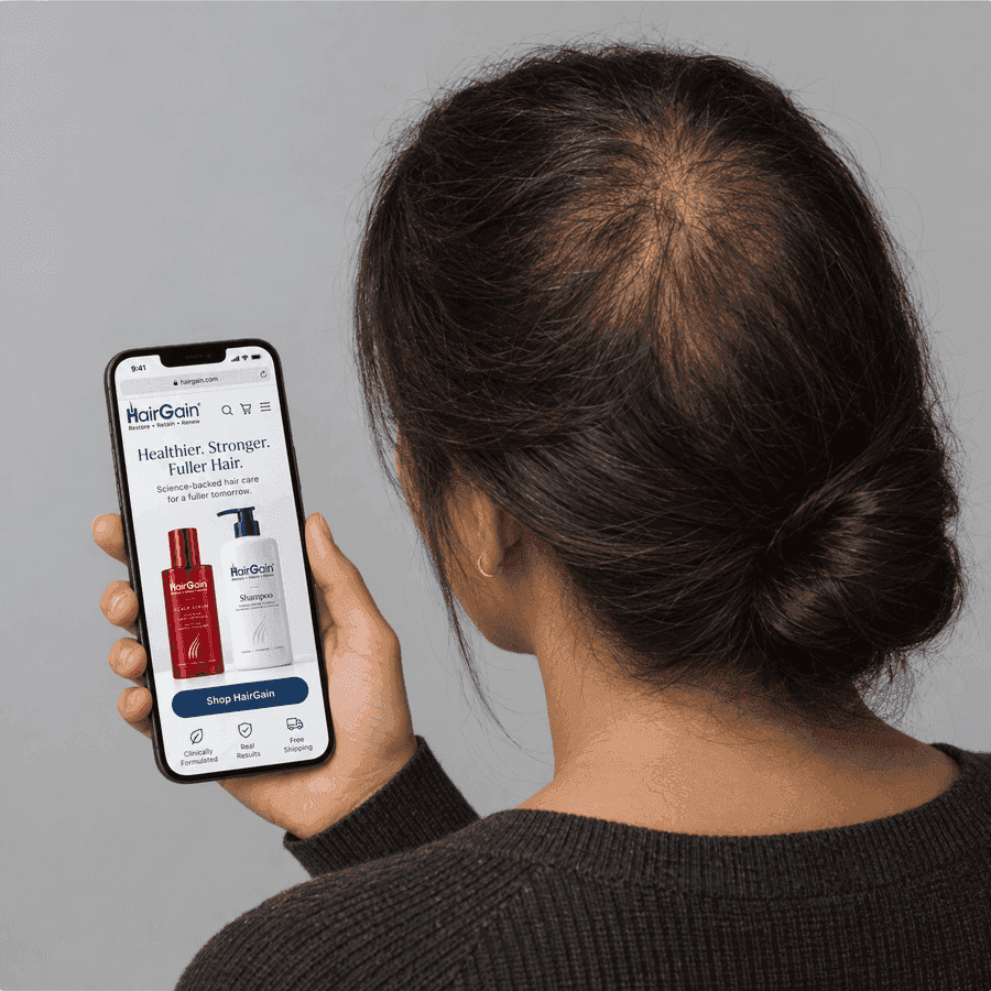 Person viewing the HairGain® website on a smartphone